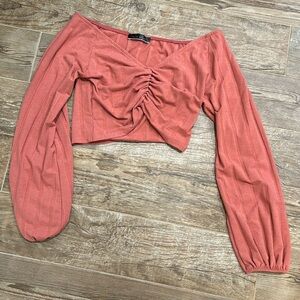 Long sleeve crop top. V-neckline. Coral color. Size small.